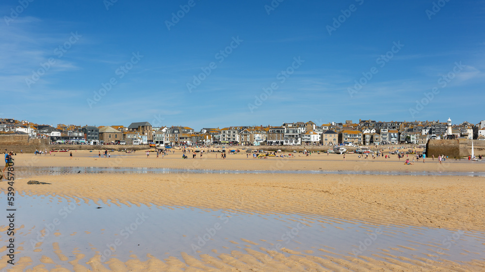 St. Ives beach during low tide revealing the sandy seabed Cornwall England 27 August 2022