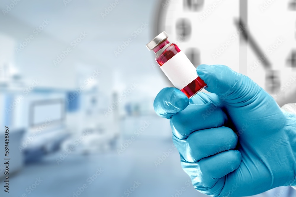 Classic medical bottle for vaccine in hands on hospital background. Classic medical bottle for vaccine in hands on hospital background.
