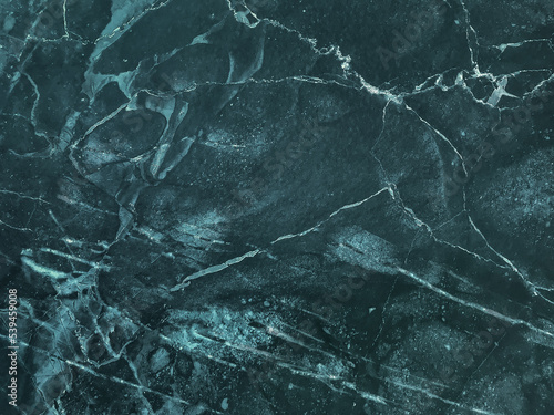 Texture of dark emerald cracked marble with lines pattern, macro background. Navy blue stone backdrop