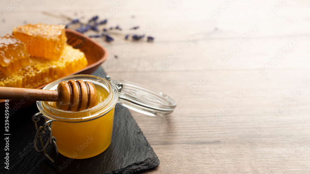 Honey on wooden honey-dipper closeup food background with copy-space Honey on wooden honey-dipper closeup food background with copy-space