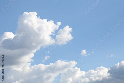 The background of the blue sky with white and gray cumulus clouds. Copy space.