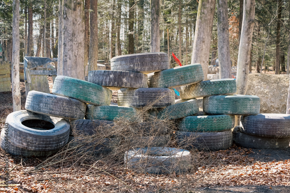 Walls of tires in the woods, paintball arena Walls of tires in the woods, paintball arena