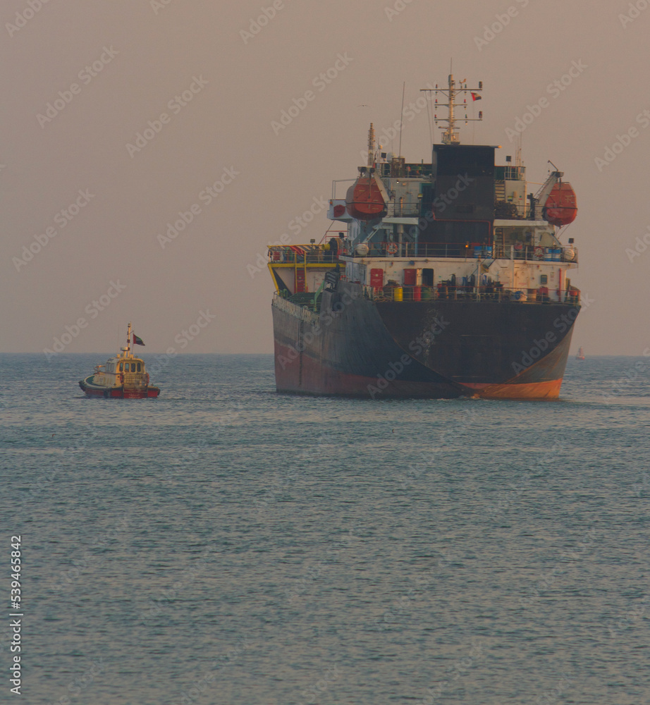 Ship leaving port with the help of pilot