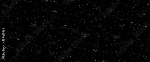 Falling snow isolated on black background. Falling snow at night. Bokeh lights on black background, flying snowflakes in the air. Winter weather. Overlay texture. © Aquarium