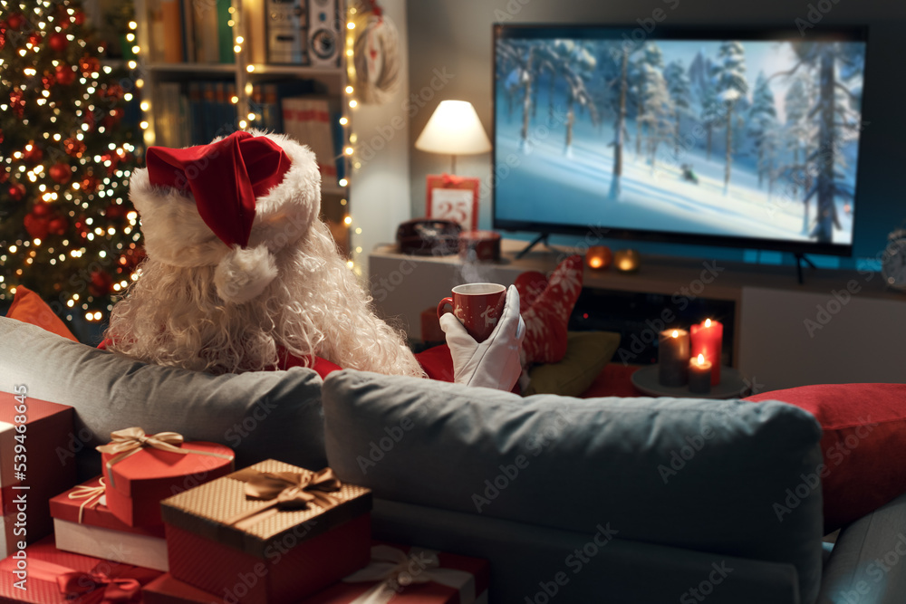 Fototapeta premium Santa Claus watching movies on TV