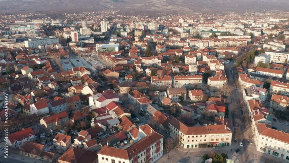 Niksic Montenegro cityscape. City center of big town in Europe. Aerial drone view of buildings and houses in the urban neighborhood. Streets going radially from roundabout, traffic circle. Niksic Montenegro cityscape. City center of big town in Europe. Aerial drone view of buildings and houses in the urban neighborhood. Streets going radially from roundabout, traffic circle.