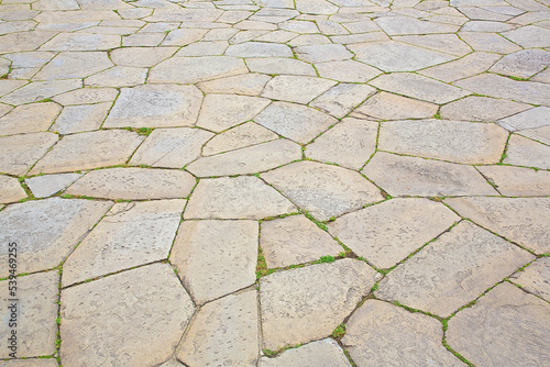 Typical traditional urban italian stone paving made with Opus Incertum irregular stone blocks photo