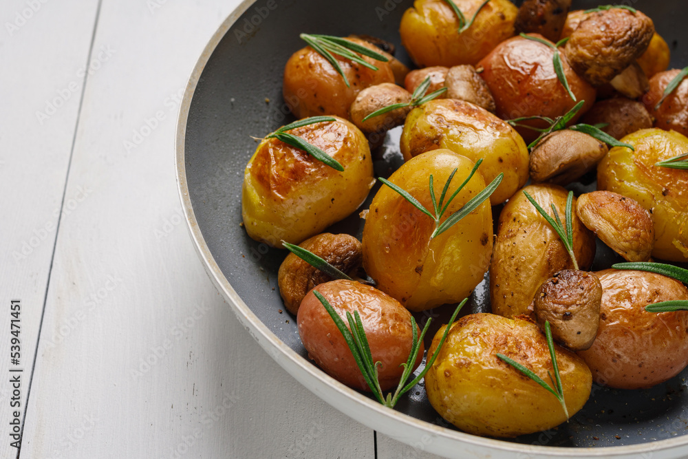 Baby potatoes fried with champignons, spices and rosemary Baby potatoes fried with champignons, spices and rosemary