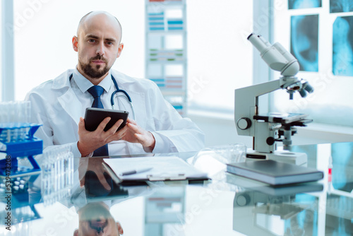 scientist using a digital tablet in a medical lab.