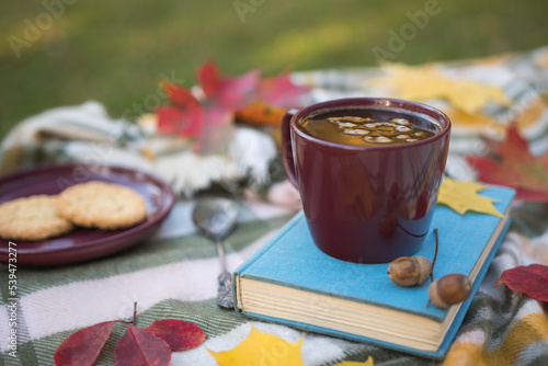 Photography Cup of black coffee standing on a blue book