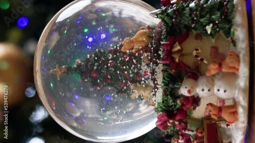 Christmas snowglobe with Christmas tree and snow falling inside 