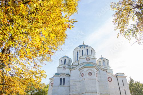 Serbian Orthodox Church, St. George’s Church In Oplenac, Topola, Serbia. Mausoleum of The Royal Family of Serbia. Beautiful Sunny Autumn Day. Clear Blue Sky With Clouds. Exterior View.  photo