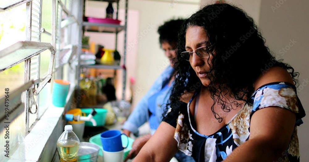 Two south american women at kitchen. domestic life, hispanic people