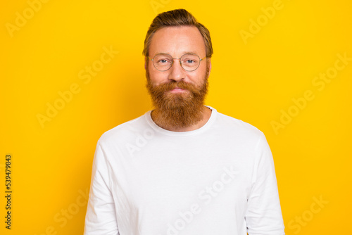 Photo of clever positive person wear eyeglasses look camera isolated on yellow color background