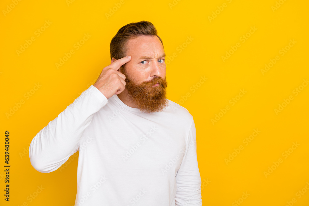Photo portrait of handsome young guy point temples smart business idea dressed trendy white pullover isolated on yellow color background Photo portrait of handsome young guy point temples smart business idea dressed trendy white pullover isolated on yellow color background