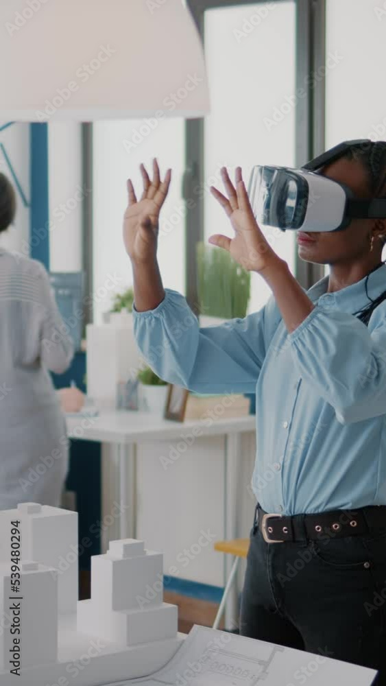 Vertical video: Architect using vr glasses to design building model and ...