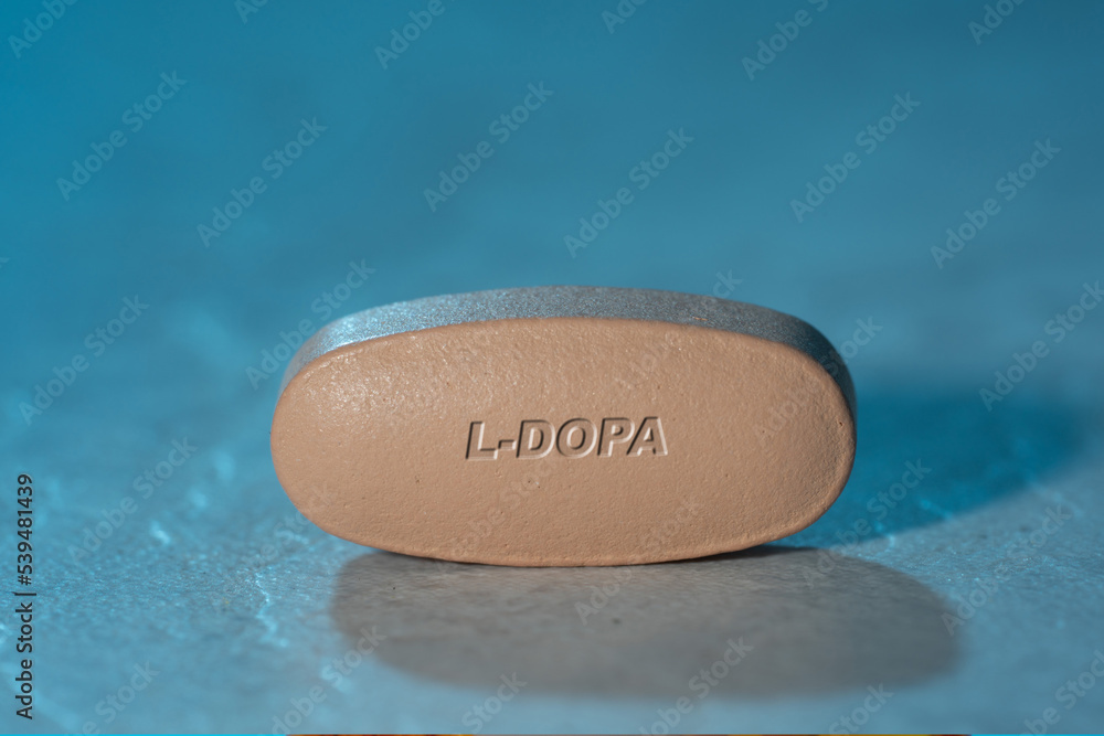 L-Dopa drug Pill Medication ob blue background L-Dopa drug Pill Medication ob blue background