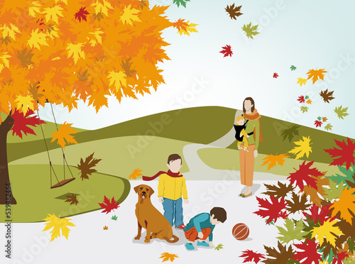 Une mère et ses trois enfants jouant dans un parc en automne avec des montagnes en fond.