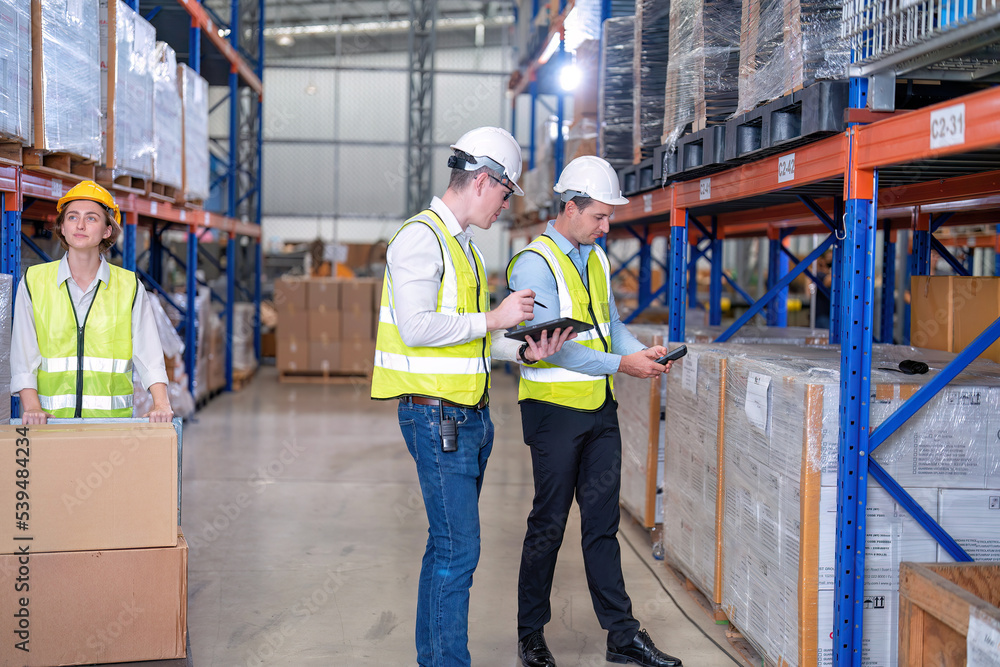 Worker in warehouse hold tablet check list perform inventory stock ...