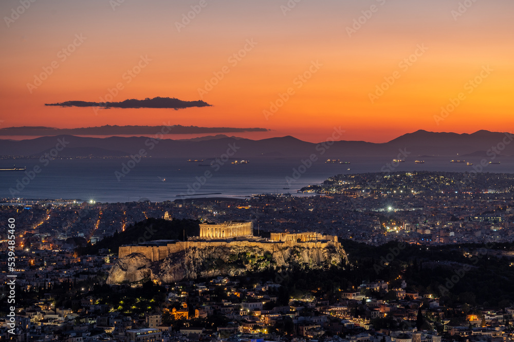 View of The Acropolis of Athens with the Parthenon seen from Mount Lycabettus after sunset.