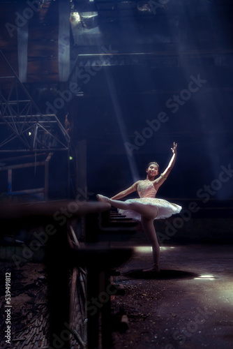 A young ballerina with a perfect body is dancing in a photo studio, dancers are dressed in fashionable outfits, this picture is taken in minimal style, showing the beauty of classical art like ballet.