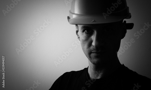 Confident young unshaven business man in light shirt protective construction helmet isolated on grey background. Achievement career wealth business concept. Mock up copy space. © Angelov