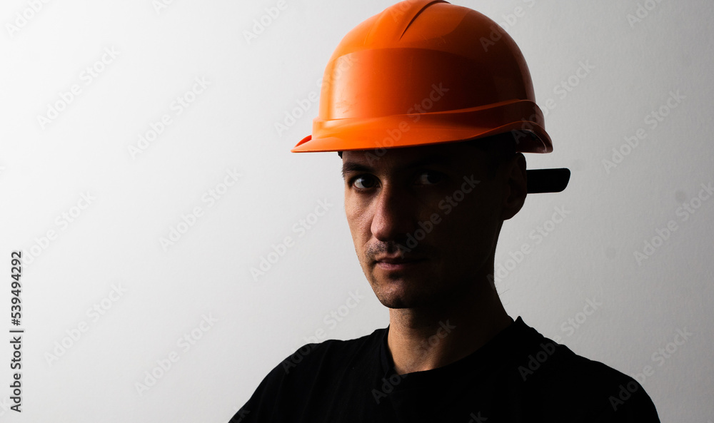 Confident young unshaven business man in light shirt protective construction helmet isolated on grey background. Achievement career wealth business concept. Mock up copy space. Confident young unshaven business man in light shirt protective construction helmet isolated on grey background. Achievement career wealth business concept. Mock up copy space.