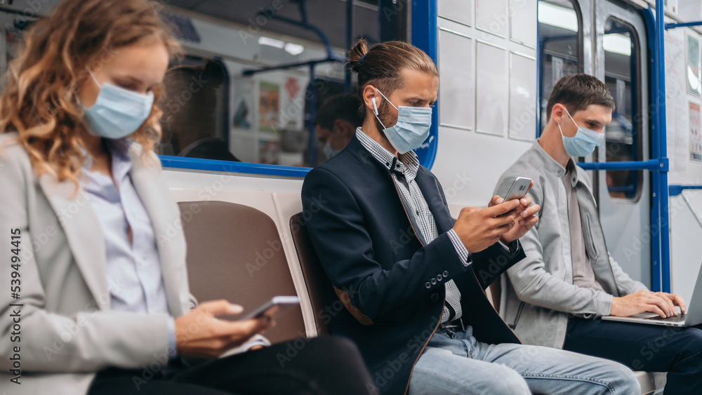 © yurolaitsalbert - passengers using their devices while sitting in a subway car . © yurolaitsalbert - passengers using their devices while sitting in a subway car .