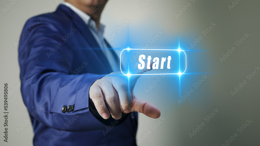 Businessman touching virtual button start. New start, beginning, business concept Businessman touching virtual button start. New start, beginning, business concept