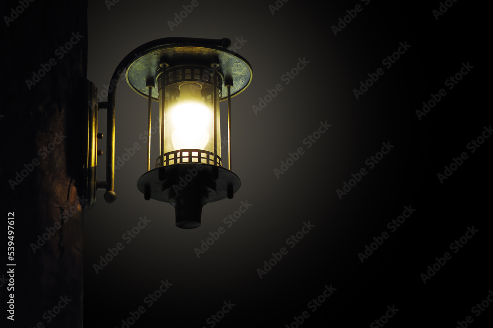 Wall vintage brass hanging lamp light in the dark night background