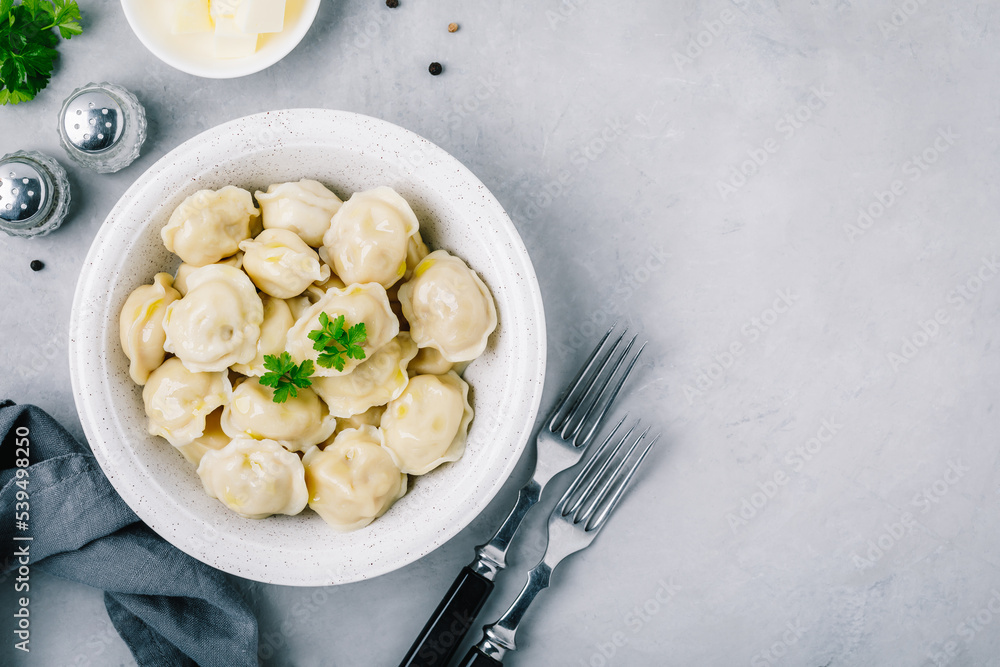 Dumplings. Meat stuffed Dumplings in a bowl on gray stone background