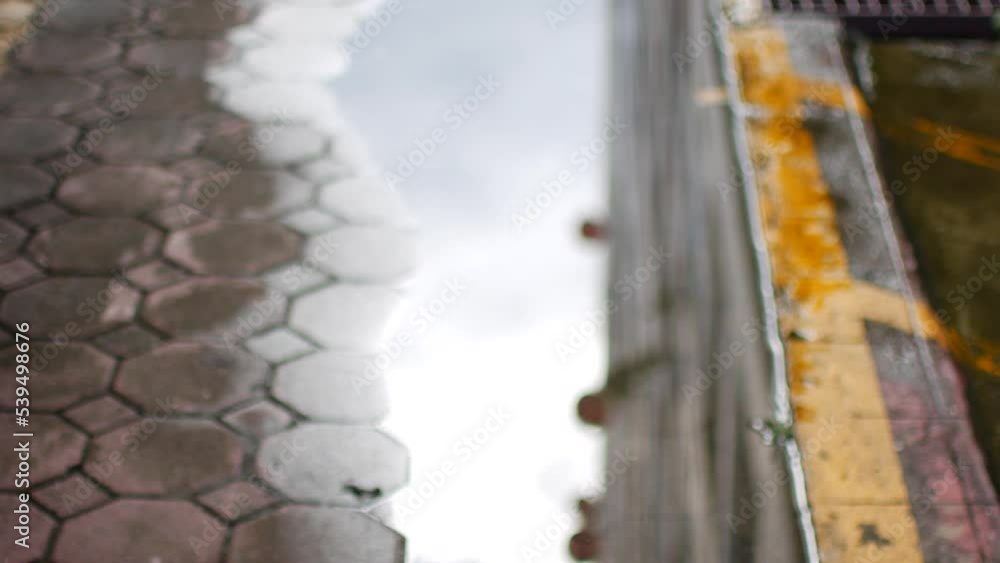 Reflection of the sky and houses in a puddle Reflection of the sky and houses in a puddle