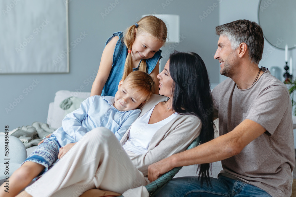 family with two children communicates in a cozy living room . family with two children communicates in a cozy living room .