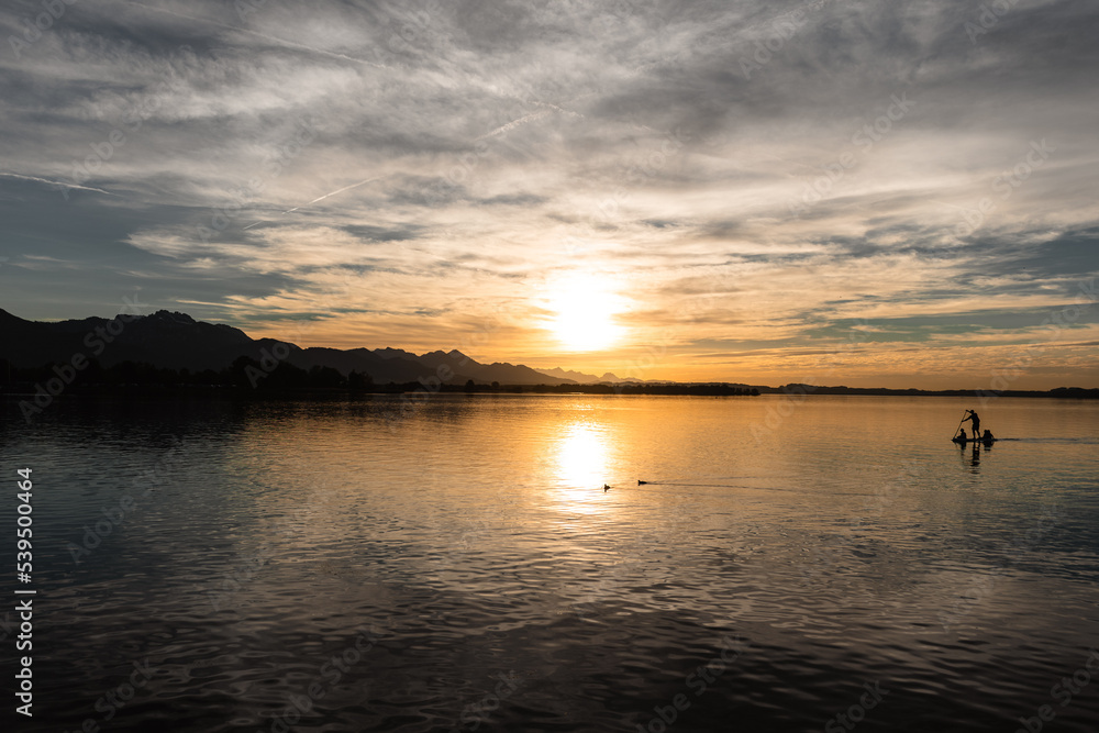 sup in sunset over the lake