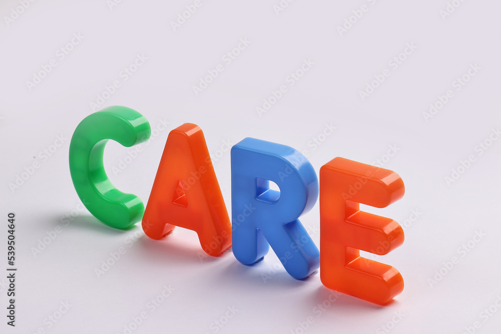 care written in red green blue plastic capital alphabet embossed colour font type sign on white background care written in red green blue plastic capital alphabet embossed colour font type sign on white background