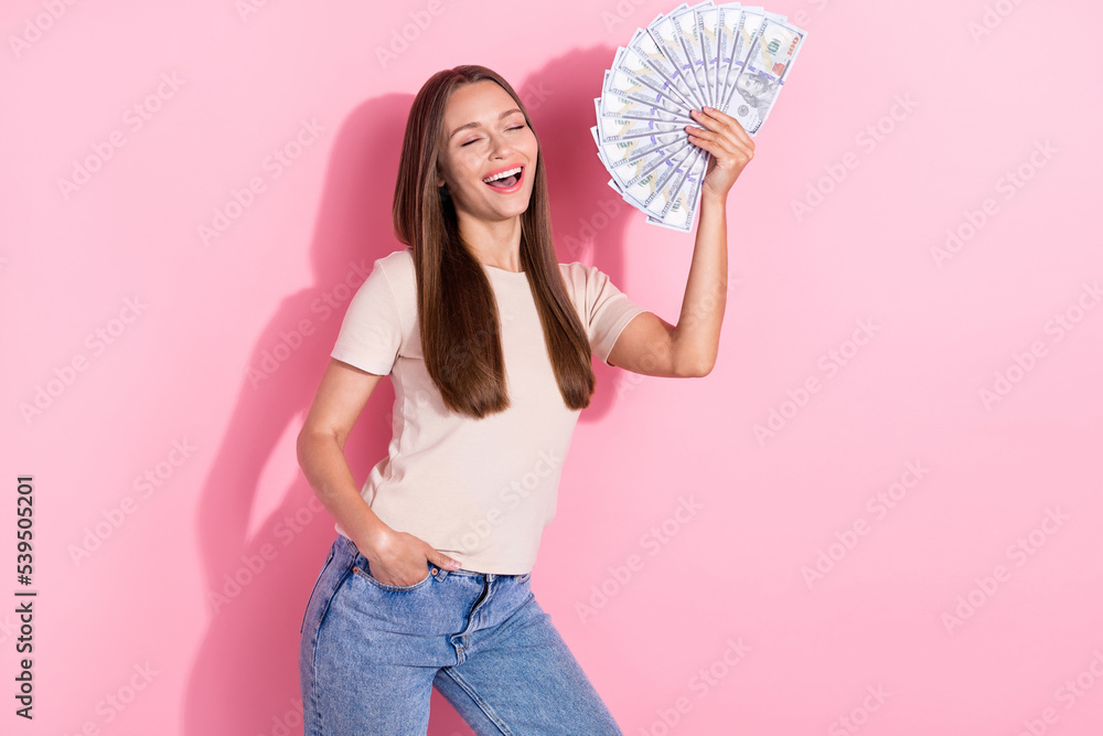 Photo of cheerful satisfied person closed eyes toothy smile hand hold cash banknotes isolated on pink color background Photo of cheerful satisfied person closed eyes toothy smile hand hold cash banknotes isolated on pink color background