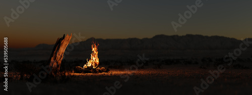 Campfire in the evening in the desert in front of desert mountains