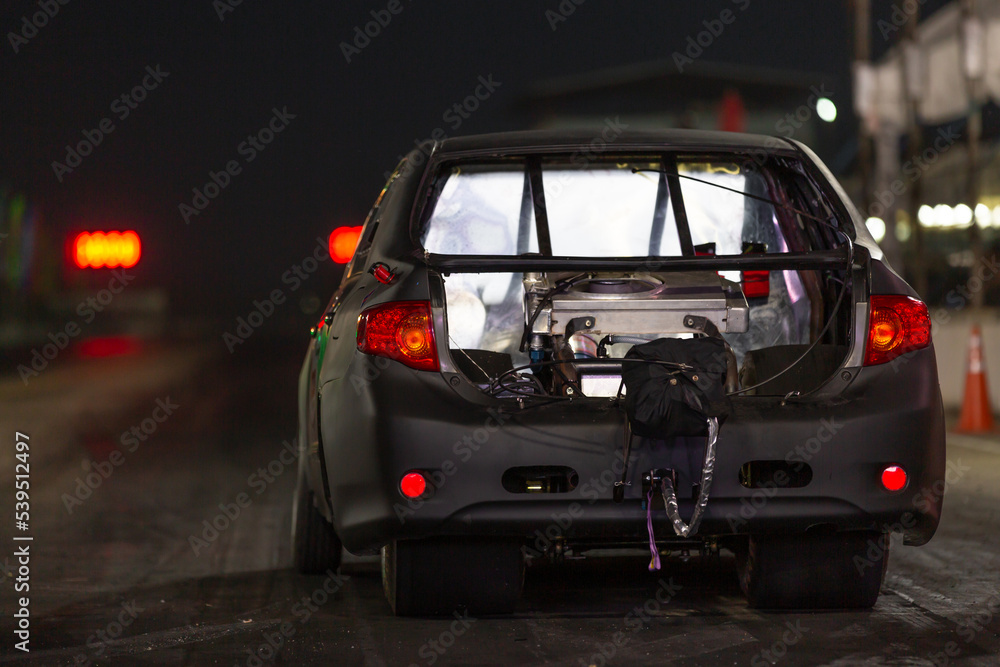 Drag racing car at the start competition at night, Drag race car in race track at night, sport car at the start, speed competition, drag racing, high speed. Drag racing car at the start competition at night, Drag race car in race track at night, sport car at the start, speed competition, drag racing, high speed.