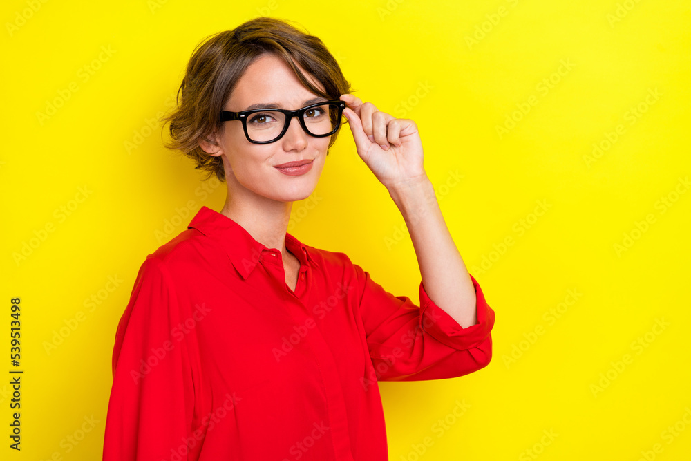 Photo of satisfied optimistic lovely woman with bob hairstyle wear red shirt hand touch glasses isolated on yellow color background Photo of satisfied optimistic lovely woman with bob hairstyle wear red shirt hand touch glasses isolated on yellow color background