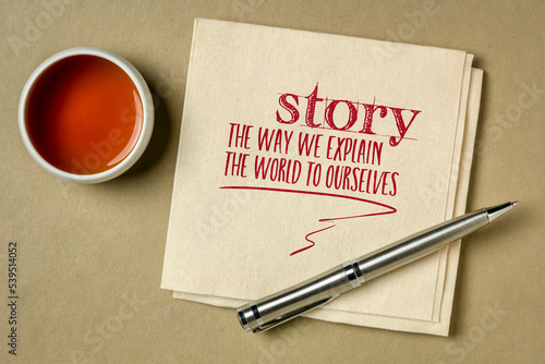 story - the way we explain the world to ourselves, handwriting on a napkin with a cup of tea, storytelling and interpretation of reality concept