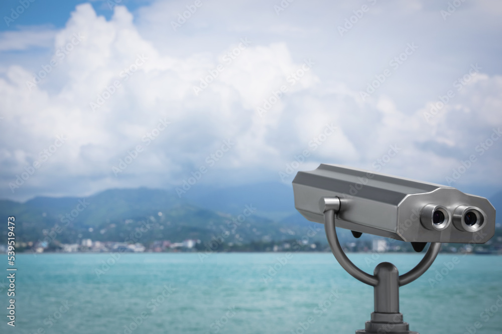 Metal tower viewer installed near sea, space for text. Mounted binoculars Metal tower viewer installed near sea, space for text. Mounted binoculars