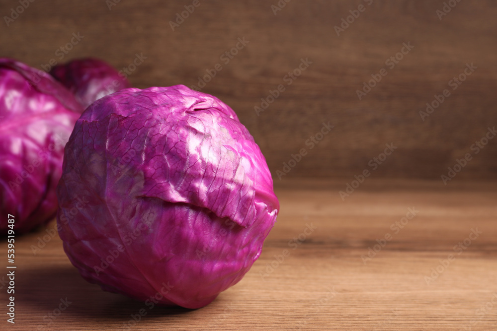 Whole ripe red cabbages on wooden table. Space for text Whole ripe red cabbages on wooden table. Space for text