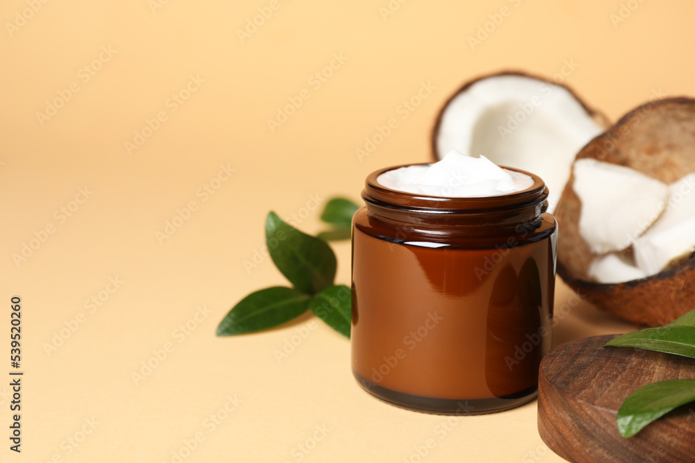 Jar of coconut face cream on light orange background. Space for text Jar of coconut face cream on light orange background. Space for text
