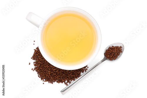 Cup of aromatic buckwheat tea and granules on white background, top view photo