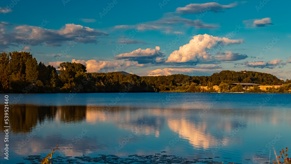 Beautiful summer view with reflections at a pond near Plattling, Isar, Bavaria, Germany