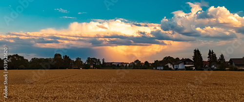 Beautiful sunset with a distant thunderstorm near Tabertshausen, Bavaria, Germany