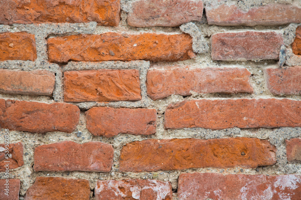 Natural stone texture for garden design, landscaping or environmentally sustainable engineering- wall or brickwork with old red bricks filled or jointed with stones and cement Natural stone texture for garden design, landscaping or environmentally sustainable engineering- wall or brickwork with old red bricks filled or jointed with stones and cement