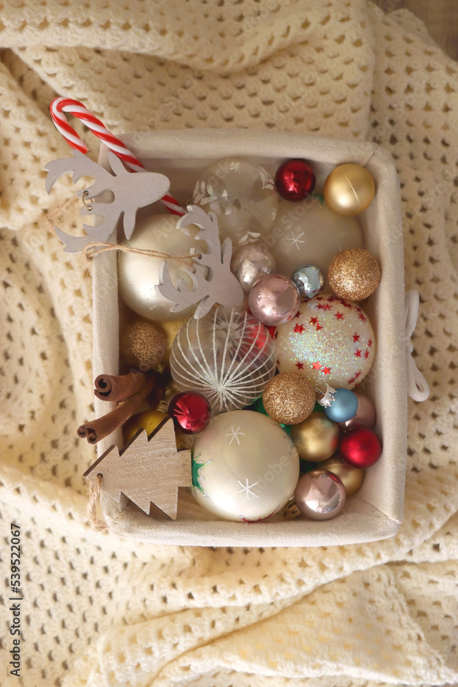 Basket with various Christmas ornaments and knitted blanket. Top view. Basket with various Christmas ornaments and knitted blanket. Top view.