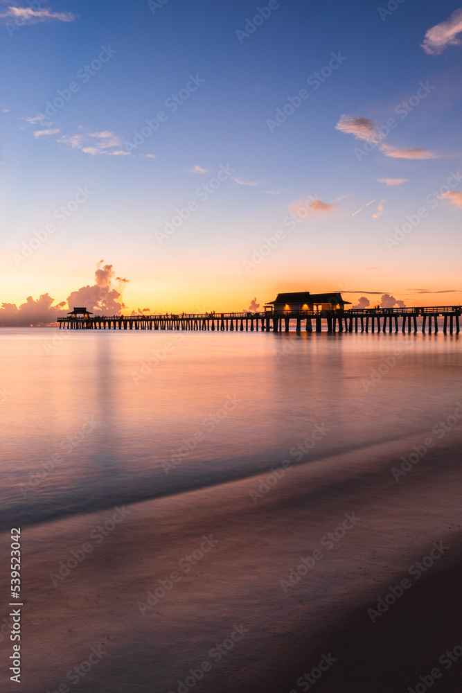 Obraz premium Naples Florida colorful sunset over the Naples beach pier South West Florida summer