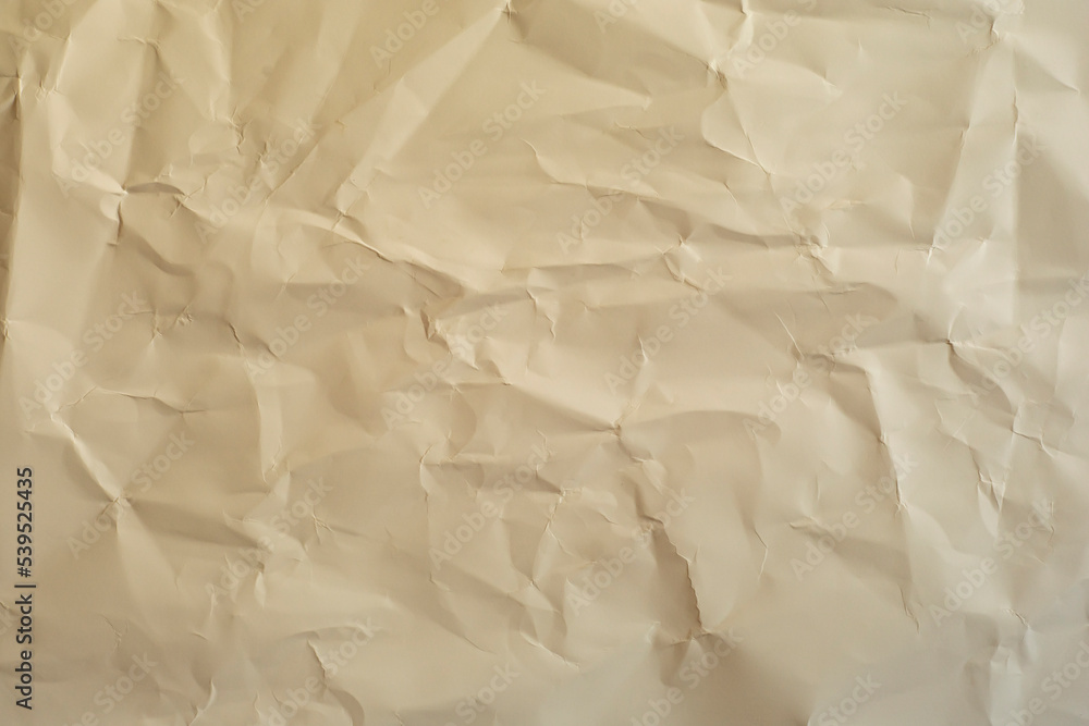 Crumpled paper in warm color as a background. Crumpled paper in warm color as a background.